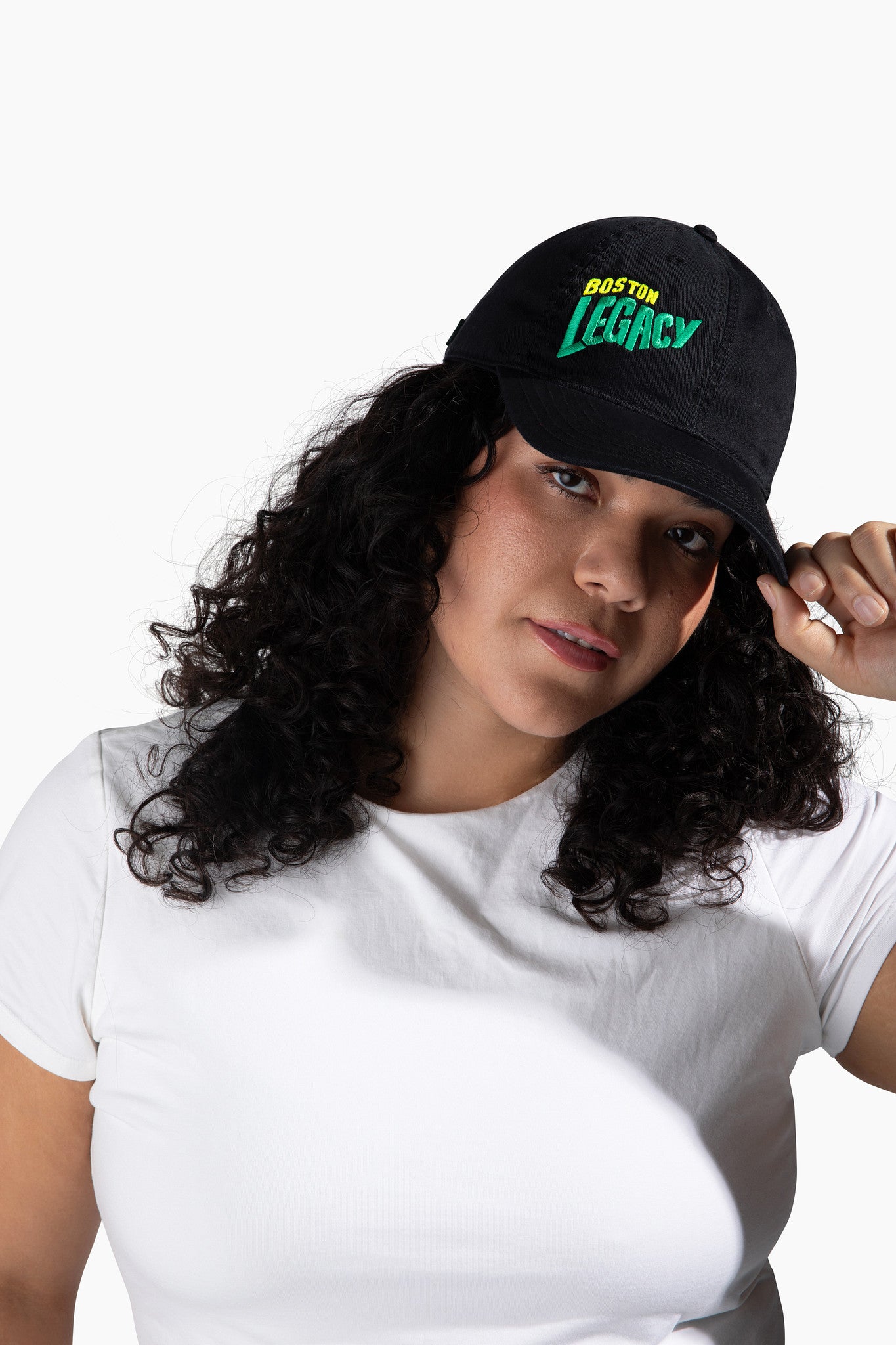 Woman wearing a black cap with 'Boston Legacy' text on a white background