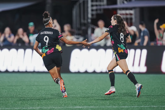 Sammy Smith celebrates with Amanda Gutierres after scoring against the Washington Spirit