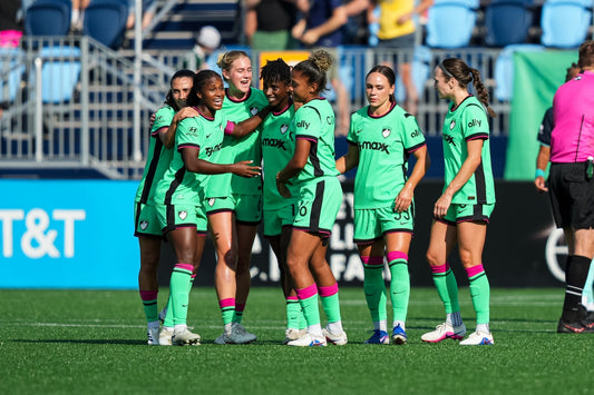Aissata Traore celebrates with teammates after scoring against the Current