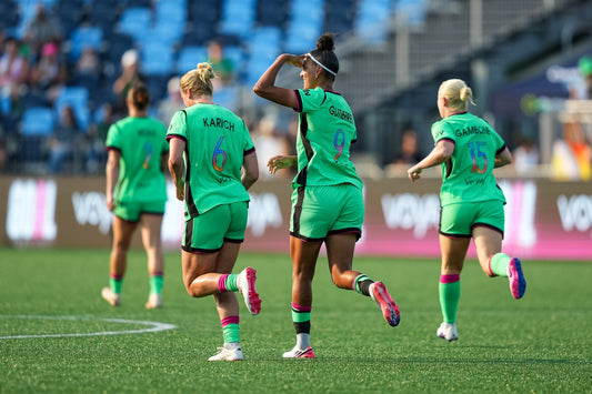 Legacy players run down the field after scoring against the Portland Thorns