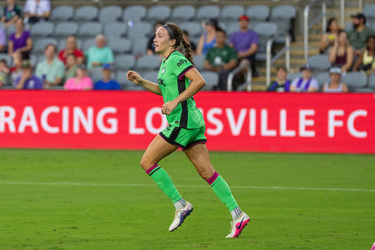 Legacy players run down the field after scoring against the Portland Thorns