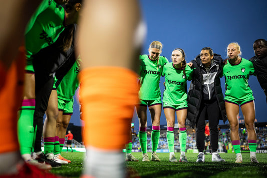 Boston Legacy players huddle on the field after their loss to the Seattle Reign