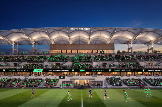Architectural rendering of the renovated White Stadium in Franklin Park, future home of Boston Legacy FC, showing a packed crowd of fans in green and black during a match with a score of BOS 2, KC 1.