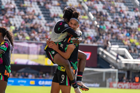 Aissata Traore and Amanda Gutierres celebrate Gutierres goal