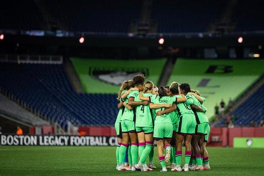 Legacy players run down the field after scoring against the Portland Thorns