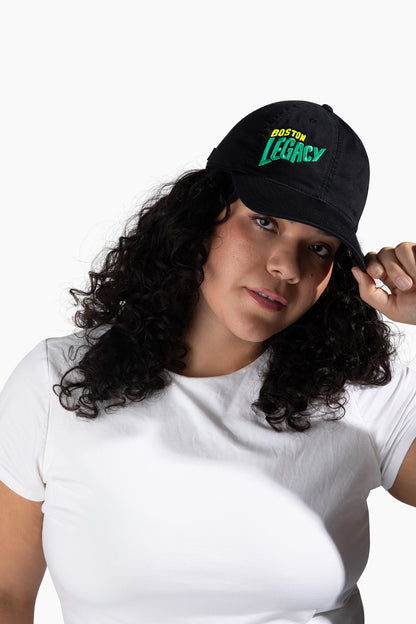 Woman wearing a black cap with 'Boston Legacy' text on a white background